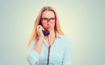 donna al telefono imbronciata